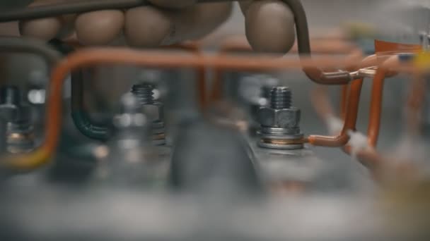 Ingenieros electricistas de planta en el trabajo instalando la mano del cable interior apriete la tuerca en el gabinete de control de la caja electiva en la caja de fusibles. Inspeccionar alimentaciones de energía eléctrica . — Vídeos de Stock