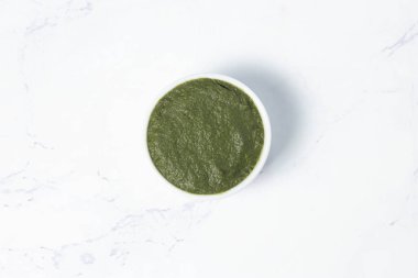 Fresh Green Chutney in bowl on marble background top view of South Asian Mint and Cilantro Dipping Sauce