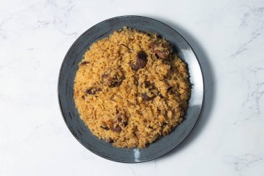 Meat Pilaf, Pulao or Biryani with Mutton or Beef, Served on a Dark Ceramic Plate top view of indian food