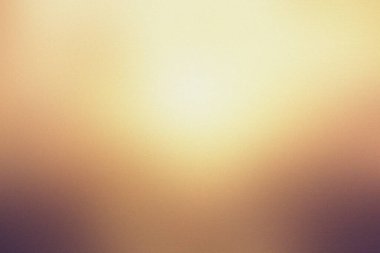 Ilık sarı, kahverengi tonları ve yumuşak ışığı olan bulanık bir arkaplan..