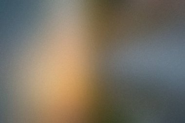 Ilık turuncu ve serin gri tonlara ve ince dokulara sahip bulanık bir arkaplan..