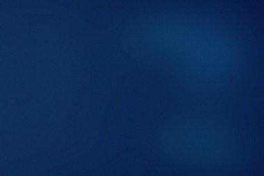 İnce ışık çizgileri ve ince tahıl dokusu olan koyu mavi bir arkaplan..