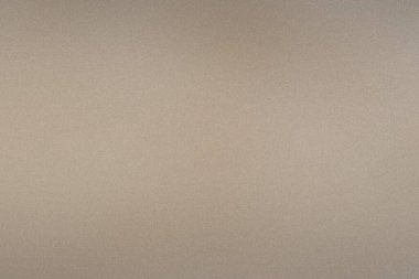 İnce bir tahıl dokusu ve ince ton değişimleriyle nötr bir bej eğimli arkaplan.