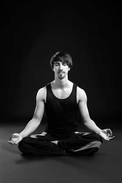 man doing yoga meditation, black and white