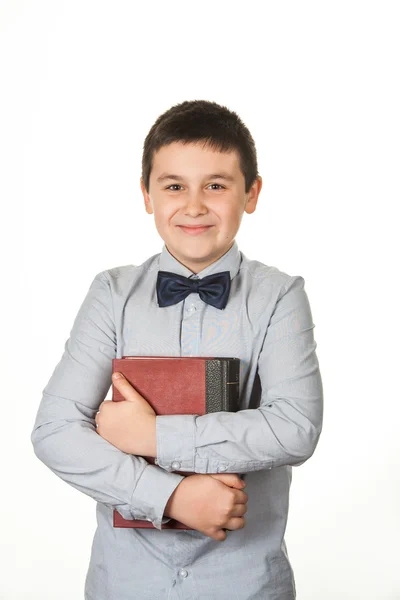 Portrait of a happy young boy, child, holding a red book — Stock Photo, Image