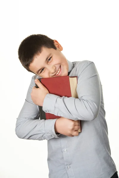 Portret van een glimlachende en mooie jonge jongen, een rode boek houden — Stockfoto