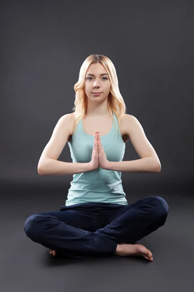 Girl practicing yoga in the lotus position Stock Photo