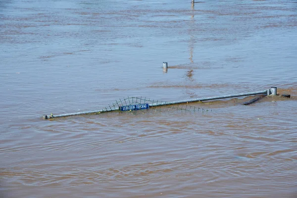 Flood water in fields, Netherlands countryside, 2021. Climate change, extreme weather, global warming. Global floods risk under climate change. Flooded wooden filed gate