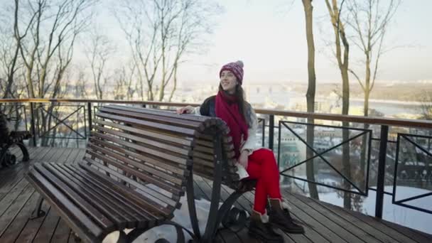 Happy romantic couple haveing a date on the bench at sunny winter day. — Stock Video