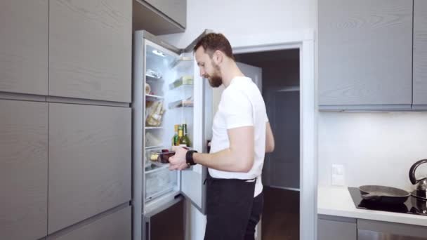 Jovem casal alegre na cozinha beber chá — Vídeo de Stock