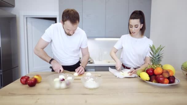 Pareja cocinando juntos en casa en la cocina — Vídeos de Stock