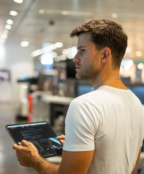 Customer with tablet choosing hardware in shop