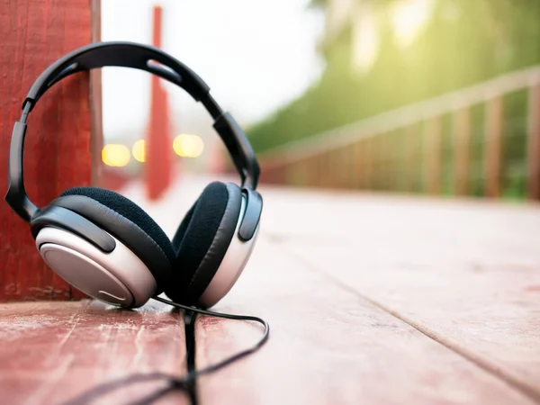 Headphone with sunlight on walk way wood