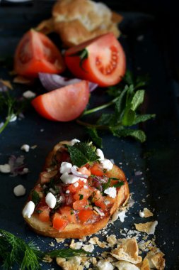 Karanlık bir arka plan üzerinde sebze salsa ile İtalyan bruschetta