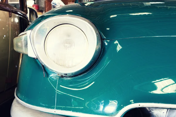 Close Up of Headlight Lamp Green Vintage Classic Car. (Vintage Effect Style)