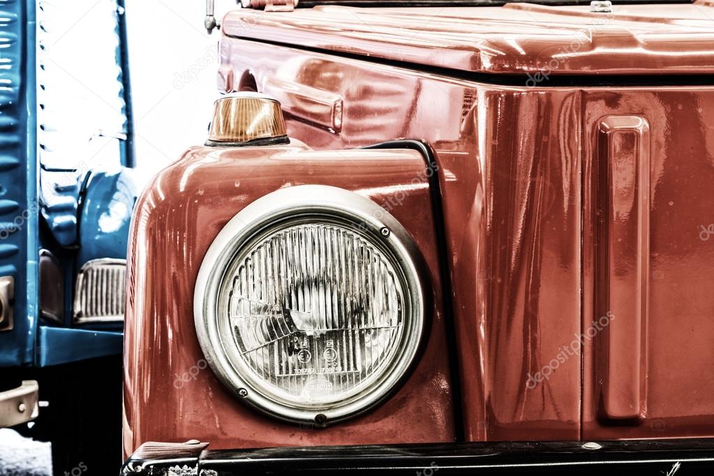 Close Up of Headlight Lamp Dark Red Vintage Classic Car. (Vintage Effect Style)