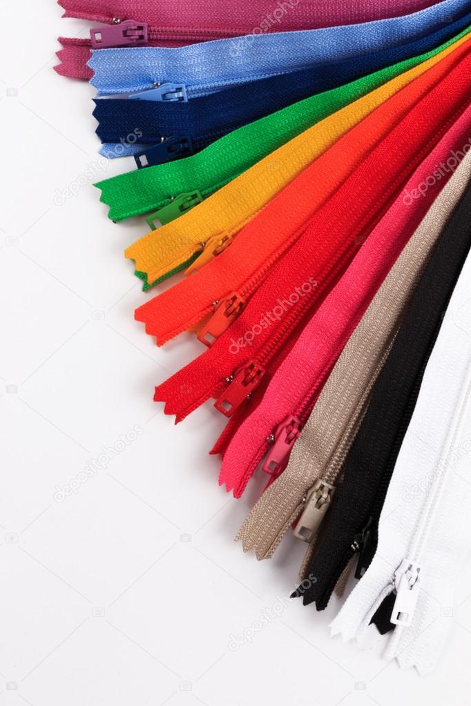 Colorful Zippers in six different colors on white background.