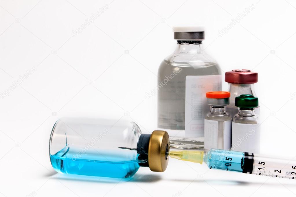 Vaccine in vial with syringe on a white background.