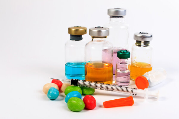 A syringe and candy bottle isolate on white background. Protect against diabetes.