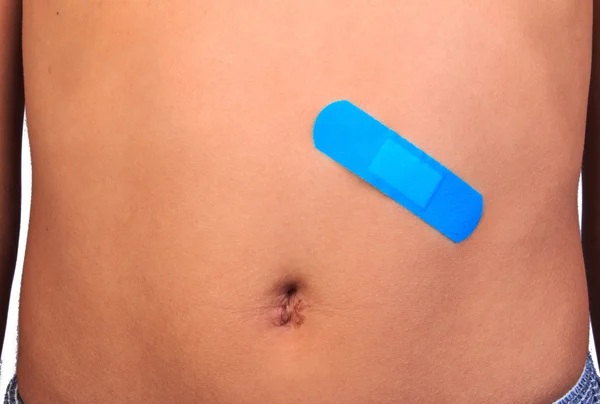 Close up bandage or plaster on an injured abdomen isolated on white background. — Stock Photo, Image
