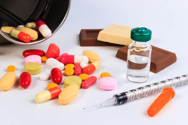 Close up of a syringe and candy on white background. Protect against diabetes. — Stock Photo, Image