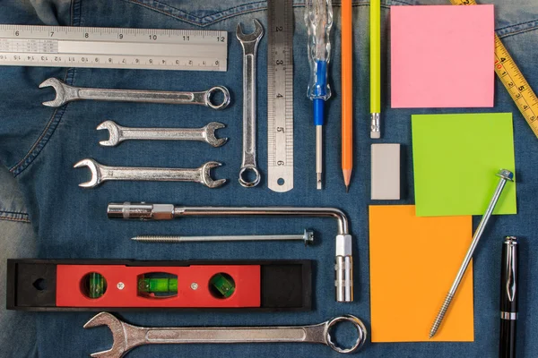 Moersleutel tools op een denim werknemers met lege Opmerking papier voor tekst. Bovenaanzicht. — Stockfoto