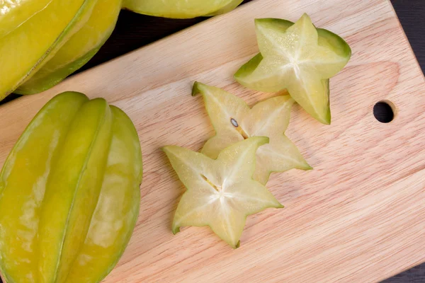 Star apple and averrhoa carambola on wooden block. Fresh star apple fruit on wood table. — Stock Photo, Image