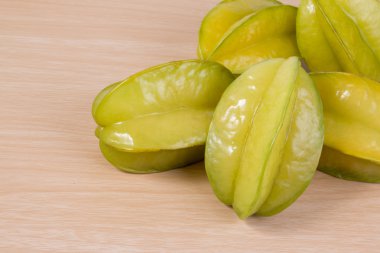 Star apple or averrhoa carambola on wooden table. Fresh star apple fruit on table.