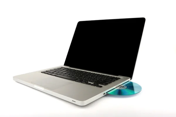 Black CD, DVD inserted into Laptop, Notebook computer on white background, close-up, isolated, white aluminium body. — ストック写真