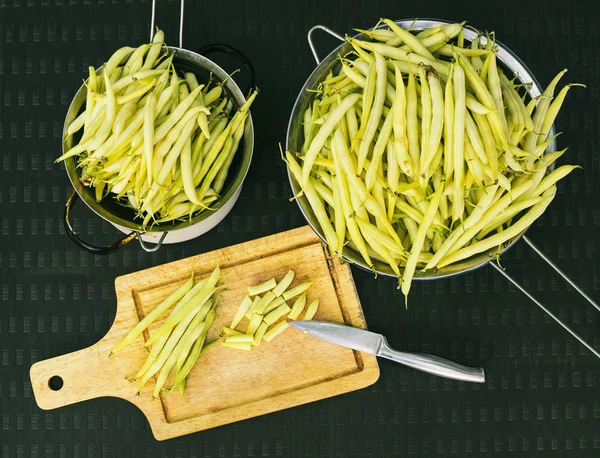 Cutting green beans on cutting board, top view