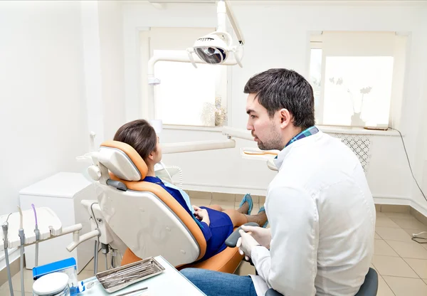 dentist in a dental clinic. The girl on reception at the dentists chair.