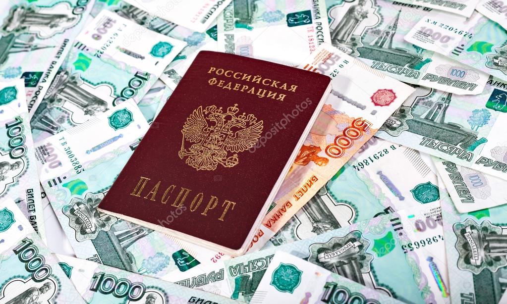 Money and Russian banknotes of denomination one and five thousand in the background. Passport of the Russian Federation