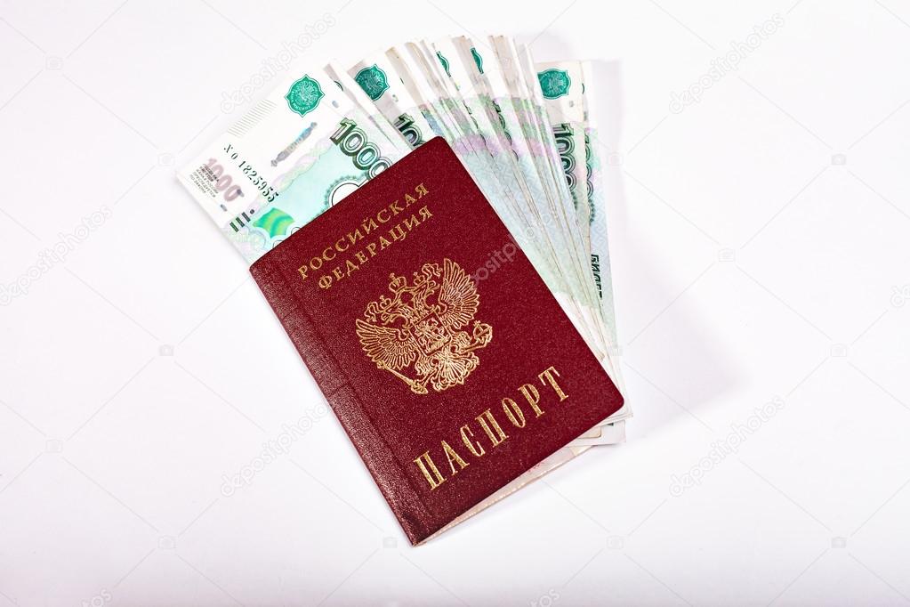 Money and Russian banknotes of denomination one and five thousand in the background. Passport of the Russian Federation