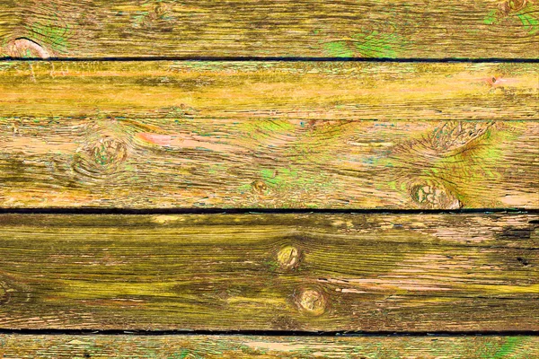 Peeling green paint. Old Grange colored wooden boards as a background with copy space. Wooden rustic background or painted wood boards texture. Boards with slots.