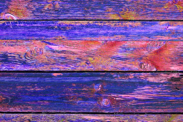 Old Grange colored wooden boards as a background with copy space. Wooden rustic background or painted wood boards texture. Boards with slots. Peeling blue and purple paint. — Stock Photo, Image