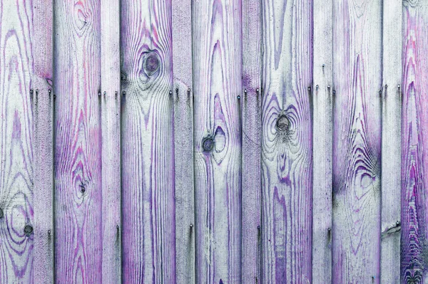 A fragment of a wooden fence. Wooden boards as a background with copy space. Wooden rustic wood boards background texture purple. — Stock Photo, Image