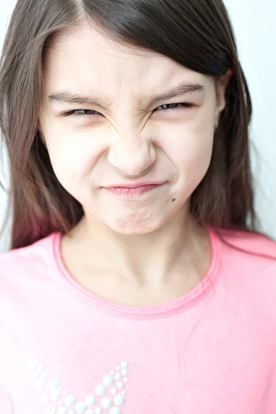 Little girl making a funny face. — Stock Photo, Image
