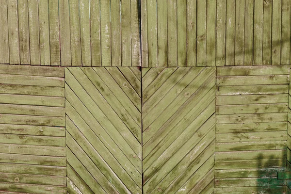 Dřevěné desky jako pozadí. Struktura toho plotu. Vintage efekt. Dřevěné desky diagonálně, vertikálně a horizontálně. stará barva na loupání. Kopírovat prostor. — Stock fotografie