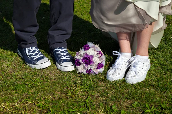 Paar, das auf dem Rasen steht. Braut und Bräutigam in Turnschuhen — Stockfoto