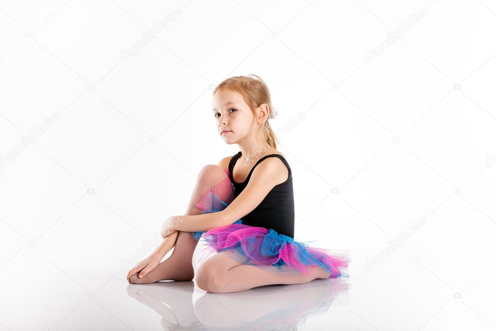 Portrait of preschool age girl is engaged in dancing, doing exer