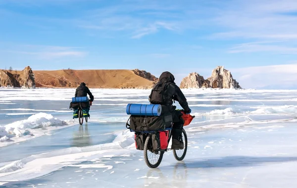 travelers on bicycles in winter at Lake Baikal