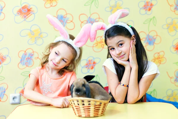portrait of two girls and two Easter bunny