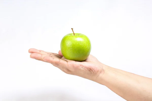 Green apple held on hand finger — Stock Photo, Image