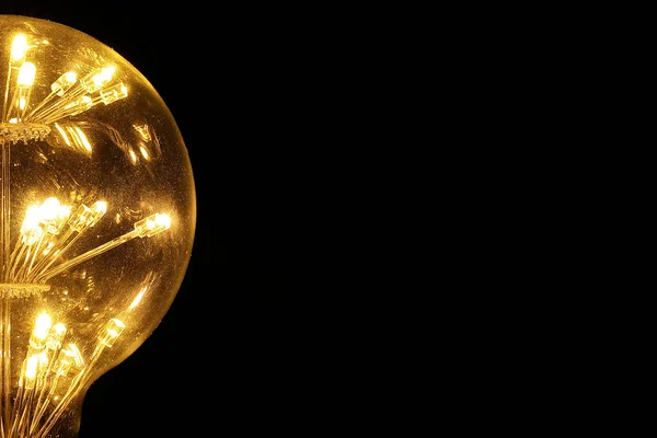 Light bulb tungsten LED on off flicker on black background