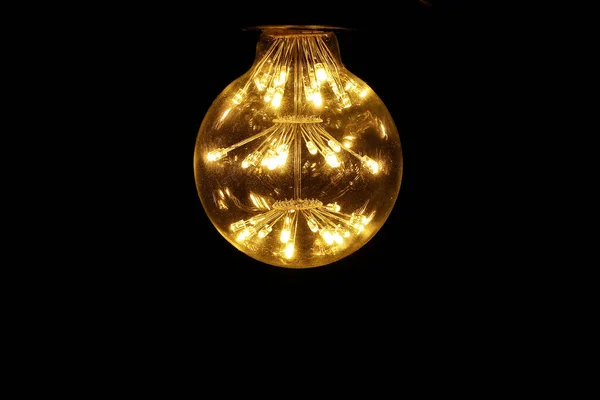 Light bulb tungsten LED on off flicker on black background
