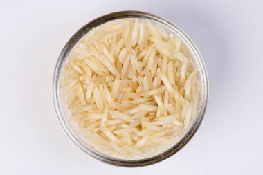 Medium grain jasmine rice in glass bowl on white background clipart