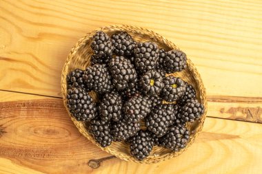 Sweet ripe blackberries on a wooden surface, macro. Top view.