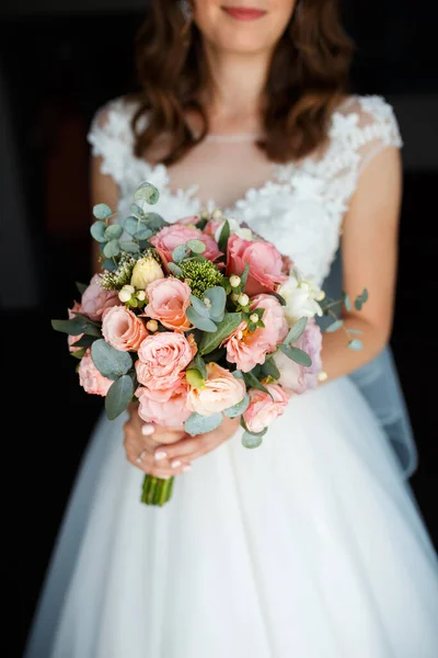 the bride holds the wedding floral bouquet in her hand, the wedding floral bouquet, the bride\'s bouquet of flowers.