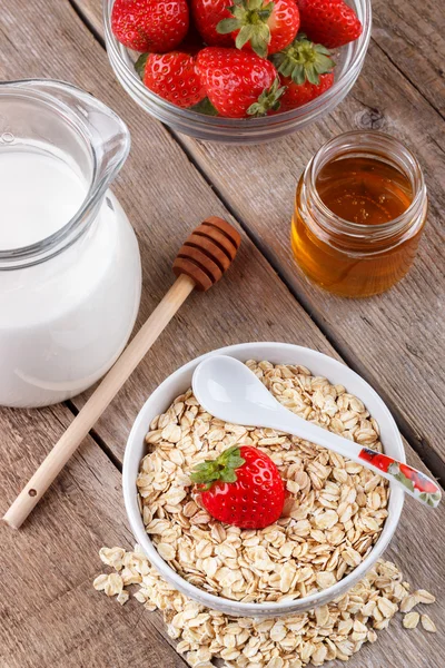 Healthy cereal with milk, honey and strawberry