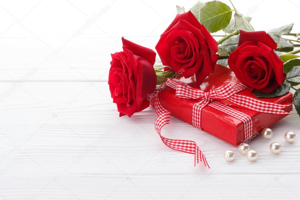Red roses and a gift box 